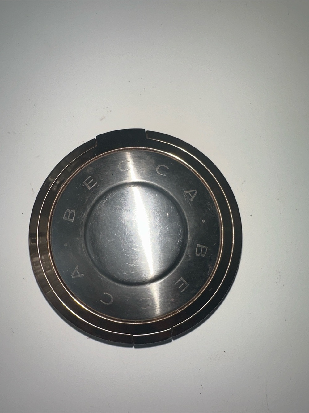 BECCA Round Metallic Compact in Silver and Rose Gold Accent